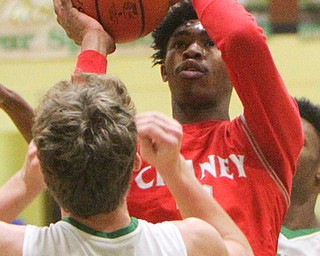 William D. Lewis The Vindicator  Chaney's (22)shoots over Ursuline's (22)  during 1-18-19 action at Ursuline.