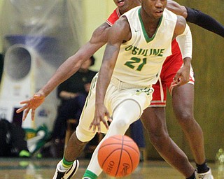 William D. Lewis The Vindicator Ursuline's RJ Clark(21) eludes Chaney's Darius Humbert (25)during 1-18-19 action at Ursuline.