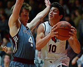 CANFIELD, OHIO - JANUARY 18, 2019: Canfield's Conor Crogan drives on Boardman's Connor Miller during the first half of their game, Friday night at Canfield High School. DAVID DERMER | THE VINDICATOR