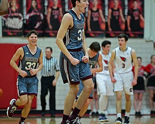 CANFIELD, OHIO - JANUARY 18, 2019: Boardman's Ethan Anderson celebrates after hitting a three point shot to beat the buzzer at the end of the first half of their game, Friday night at Canfield High School. DAVID DERMER | THE VINDICATOR..Boardman's Marco Stilliana, Canfield's Brayden Beck pictured.