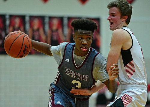 CANFIELD, OHIO - JANUARY 18, 2019: Boardman's Derrick Anderson drives on Canfield's Brent Herrmann during the second half of their game, Friday night at Canfield High School. DAVID DERMER | THE VINDICATOR.