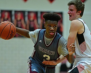 CANFIELD, OHIO - JANUARY 18, 2019: Boardman's Derrick Anderson drives on Canfield's Brent Herrmann during the second half of their game, Friday night at Canfield High School. DAVID DERMER | THE VINDICATOR.