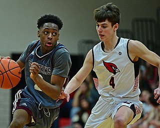 CANFIELD, OHIO - JANUARY 18, 2019: Boardman's Che Trevena drives on Canfield's Jake Kowal during the second half of their game, Friday night at Canfield High School. DAVID DERMER | THE VINDICATOR