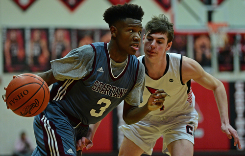CANFIELD, OHIO - JANUARY 18, 2019: Boardman's Derrick Anderson drives on Canfield's Jake Kowal during the second half of their game, Friday night at Canfield High School. DAVID DERMER | THE VINDICATOR