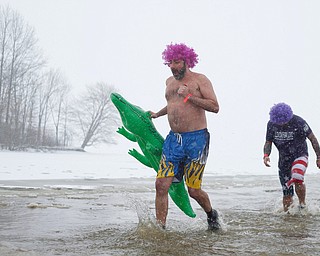 Dan Goddard, of Champion, left, and Mike Watson, of Niles, right, both with the group Livin' for Livi, participate in the Annual Polar Plunge in Mosquito Lake in Cortland on Saturday. The group was created after Watson's daughter Livi passed away after getting hit by a drunk driver. EMILY MATTHEWS | THE VINDICATOR