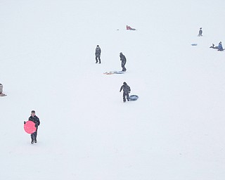 People sled ride at Wick Recreation Area on Saturday afternoon. EMILY MATTHEWS | THE VINDICATOR