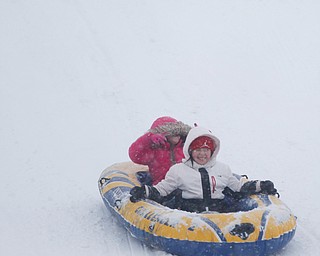 Natalee Scott, 9, front, and Isabelle Cordova, 5, both of Austintown, sled ride at Wick Recreation Area on Saturday afternoon. EMILY MATTHEWS | THE VINDICATOR