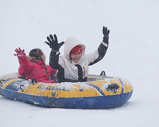 Natalee Scott, 9, right, and Isabelle Cordova, 5, both of Austintown, sled ride at Wick Recreation Area on Saturday afternoon. EMILY MATTHEWS | THE VINDICATOR