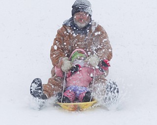 Jason Dean and Mila Cain, 1, of Cornersburg, sled ride at Wick Recreation Area on Saturday afternoon. EMILY MATTHEWS | THE VINDICATOR