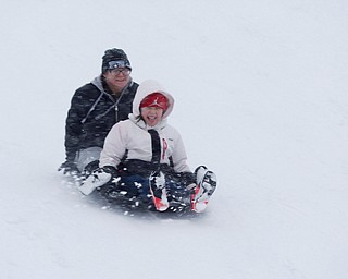 Samantha Jones, back, and Natalee Scott, 9, both of Austintown, sled ride at Wick Recreation Area on Saturday afternoon. EMILY MATTHEWS | THE VINDICATOR