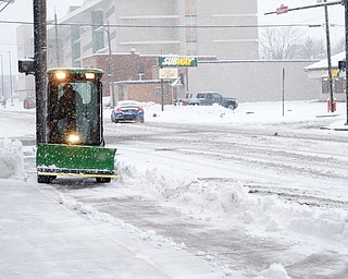 Michael Depizzo, of Liberty and with Depco Inc., plows a sidewalk on West Rayen Avenue on Saturday afternoon. EMILY MATTHEWS | THE VINDICATOR