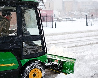 Michael Depizzo, of Liberty and with Depco Inc., plows a sidewalk on West Rayen Avenue on Saturday afternoon. EMILY MATTHEWS | THE VINDICATOR