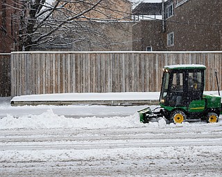 Michael Depizzo, of Liberty and with Depco Inc., plows a sidewalk on West Rayen Avenue on Saturday afternoon. EMILY MATTHEWS | THE VINDICATOR