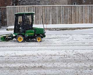 Michael Depizzo, of Liberty and with Depco Inc., plows a sidewalk on West Rayen Avenue on Saturday afternoon. EMILY MATTHEWS | THE VINDICATOR