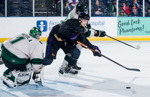 Scott R. Galvin | The Vindicator.Youngstown Phantoms forward Trevor Kuntar (16) reaches for the puck against Cedar Rapids RoughRiders defenseman Mitchell Miller (28) during the first period at the Covelli Centre on Saturday, January 19, 2019.  The Phantoms lost 4-2.