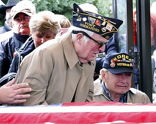 In this Jan. 17, 2019, photo, two elderly veterans were among the last to arrive at a service to bury three Memphis veterans who died this past fall and whose remains were unclaimed in Memphis, Tenn. The veterans were buried at the West Tennessee Veterans Cemetery with honors.