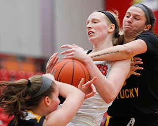 YSU's Sarah Cash tries to hold onto the ball as Northern Kentucky's Jazmyne Geist, right, and Kailey Coffey try to grab it during their game in Beeghly Center on Monday afternoon. EMILY MATTHEWS | THE VINDICATOR