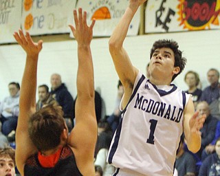 William D. Lewis The Vindicator McDonald's Zach Rasile(1) shoots for 3 over Springfield's (Shane eEnon)12 during1-22-19 action at McDonald.