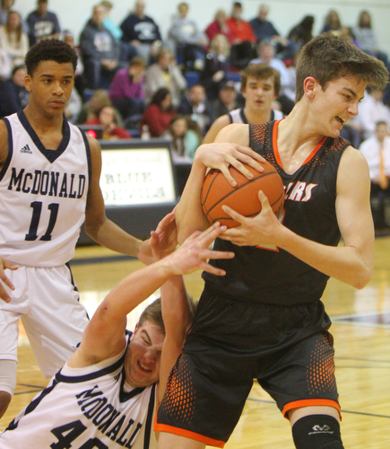William D. Lewis The Vindicator Springfield's Evan Ohlin(1) and McDonald's JAke Portolese(40) fight for the ball while McDonald'sCam Tucker(11) looks on during1-22-19 action at McDonald.