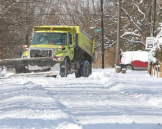 A Youngstown snow plow finishes cleaning up the intersection at Adelaide and Livingston streets on the East Side. It took until early Tuesday for Youngstown street department crews to take a first pass on every street in the city.