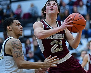 WARREN, OHIO - JANUARY 23, 2019: Boardman's Cam Kreps goes to the basket around Harding's Elizah Smith during the first half of their game, Wednesday night at Warren Harding High School. DAVID DERMER | THE VINDICATOR