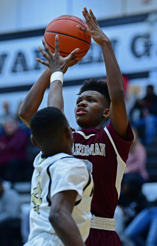 WARREN, OHIO - JANUARY 23, 2019: Boardman's Derrick Anderson puts up a shot over Harding's Dominic Foster during the first half of their game, Wednesday night at Warren Harding High School. DAVID DERMER | THE VINDICATOR