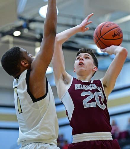 WARREN, OHIO - JANUARY 23, 2019: Boardman's Shay Eicher puts up a shot over Harding's Aston Bates during the first half of their game, Wednesday night at Warren Harding High School. DAVID DERMER | THE VINDICATOR