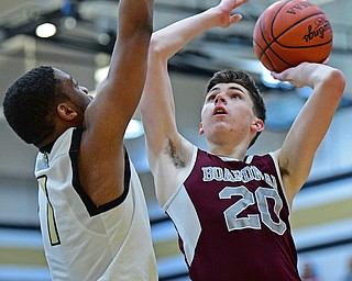 WARREN, OHIO - JANUARY 23, 2019: Boardman's Shay Eicher puts up a shot over Harding's Aston Bates during the first half of their game, Wednesday night at Warren Harding High School. DAVID DERMER | THE VINDICATOR