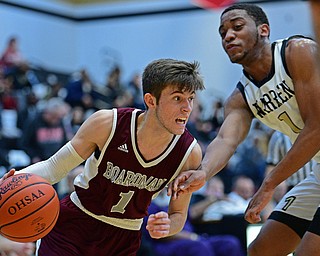 WARREN, OHIO - JANUARY 23, 2019: Boardman's Tommy Fryda drives on Harding's Aston Bates during the first half of their game, Wednesday night at Warren Harding High School. DAVID DERMER | THE VINDICATOR