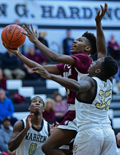 WARREN, OHIO - JANUARY 23, 2019: Boardman's Derrick Anderson goes to the basket while being pressured by Harding's Jabari Felton during the second half of their game, Wednesday night at Warren Harding High School. DAVID DERMER | THE VINDICATOR