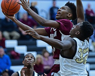 WARREN, OHIO - JANUARY 23, 2019: Boardman's Derrick Anderson goes to the basket while being pressured by Harding's Jabari Felton during the second half of their game, Wednesday night at Warren Harding High School. DAVID DERMER | THE VINDICATOR