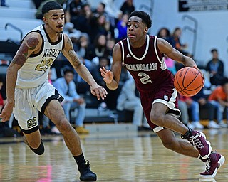 WARREN, OHIO - JANUARY 23, 2019: Boardman's Che Trevena drives on Harding's Dom McGee during the second half of their game, Wednesday night at Warren Harding High School. DAVID DERMER | THE VINDICATOR