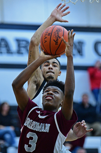 WARREN, OHIO - JANUARY 23, 2019: Boardman's Derrick Anderson goes to the basket before having his shot blocked by Harding's Dom McGee during the second half of their game, Wednesday night at Warren Harding High School. DAVID DERMER | THE VINDICATOR