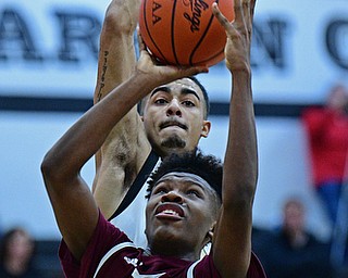 WARREN, OHIO - JANUARY 23, 2019: Boardman's Derrick Anderson goes to the basket before having his shot blocked by Harding's Dom McGee during the second half of their game, Wednesday night at Warren Harding High School. DAVID DERMER | THE VINDICATOR