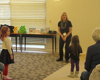 Neighbors | Jessica Harker.Children gathered at the Austintown library Jan. 3 to listen to children's librarian Lindsay Cramer during the library's Gotta Move story time.