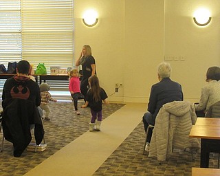 Neighbors | Jessica Harker.Librarian Lindsay Cramer danced with children gathered at the Austintown library on Jan. 3 for the Gotta Move story time.