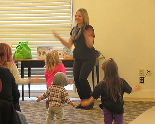 Neighbors | Jessica Harker.Lindsay Cramer, the children's librarian at Austintown library, warmed up for the Gotta Move story time, dancing to music with the children gathered at the event.