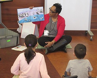 Neighbors | Jessica Harker.Librarian Rhonda Monroe read to children gathered at the Michael Kusalaba library for the Read and Make event, which was penguin themed.