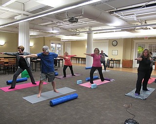 Neighbors | Jessica Harker.Community members practiced a warrior pose for the weekly yoga class hosted at the Poland library Jan. 2.