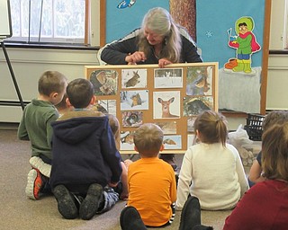 Neighbors | Jessica Harker.An interactive board with photos of animals in Mill Creek Park was used by Naturalist Marilyn Williams during the Jan. 10 Little Explorers meeting at Ford Nature Center.