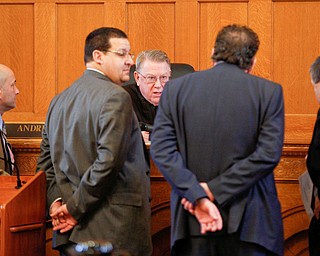Judge Andrew Logan, center, speaks to, from left, defense attorney David Rouzzo, defense attorney John Cornely, assistant prosecutor Chris Becker, and Trumbull County prosecutor Dennis Watkins during Claudia Hoerig's trial on Thursday. EMILY MATTHEWS | THE VINDICATOR