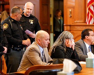 Claudia Hoerig cries as she sits between her attorneys David Rouzzo, left, and John Cornely while they wait for the jury's verdict on Thursday. EMILY MATTHEWS | THE VINDICATOR