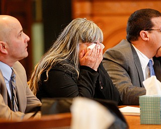 Claudia Hoerig cries as she sits between her attorneys David Rouzzo, left, and John Cornely while they wait for the jury's verdict on Thursday. EMILY MATTHEWS | THE VINDICATOR
