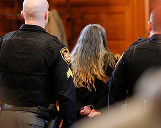 Claudia Hoerig is walked out of the court room after she is found guilty of aggravated murder on Thursday. EMILY MATTHEWS | THE VINDICATOR