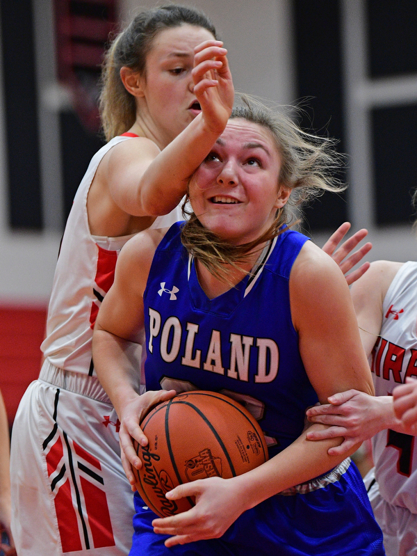 GIRARD, OHIO - JANUARY 24, 2019: Poland's Morgan Kluchar goes to the basket while being bumped by Girard's Rachel Sobnosky during the first half of their game, Thursday night at Girard High School. DAVID DERMER | THE VINDICATOR