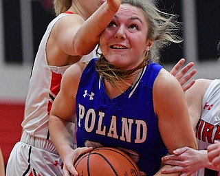 GIRARD, OHIO - JANUARY 24, 2019: Poland's Morgan Kluchar goes to the basket while being bumped by Girard's Rachel Sobnosky during the first half of their game, Thursday night at Girard High School. DAVID DERMER | THE VINDICATOR