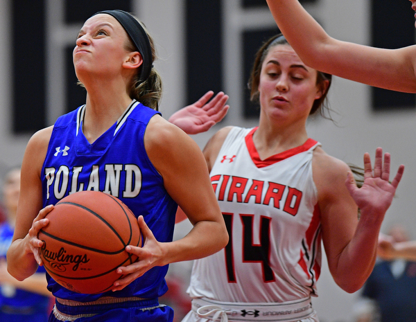 GIRARD, OHIO - JANUARY 24, 2019: Poland's Sarah Bury goes to the basket past Girard's Lindsay Cave during the first half of their game, Thursday night at Girard High School. DAVID DERMER | THE VINDICATOR
