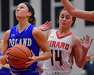 GIRARD, OHIO - JANUARY 24, 2019: Poland's Sarah Bury goes to the basket past Girard's Lindsay Cave during the first half of their game, Thursday night at Girard High School. DAVID DERMER | THE VINDICATOR