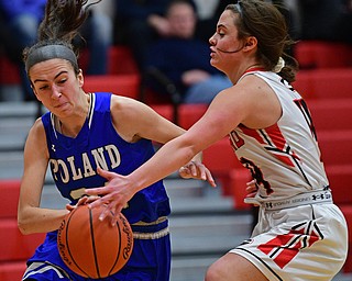 GIRARD, OHIO - JANUARY 24, 2019: Poland's Jackie Grisdale drives on Girard's Lindsay Cave during a time out during the first half of their game, Thursday night at Girard High School. DAVID DERMER | THE VINDICATOR