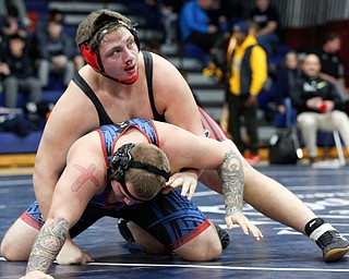 Girard's Connor Moore, top, and Ravenna's Shawn Jeffers wrestle during the final round of the Josh Hephner Memorial Wrestling Tournament at Austintown Fitch High School on Saturday. Moore won the round came in fifth in the 285 weight class. EMILY MATTHEWS | THE VINDICATOR